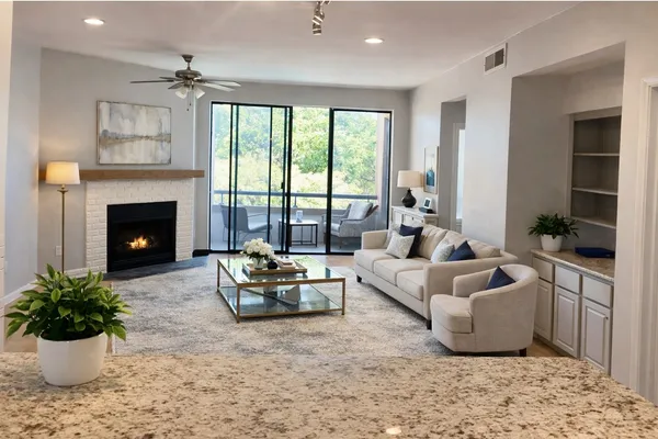 a living room with furniture and a fireplace