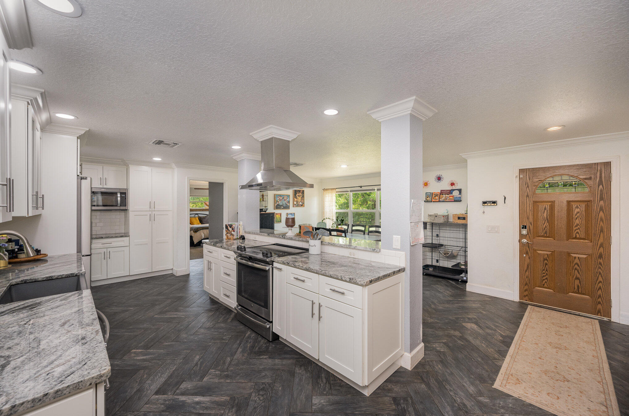 3650 Corey Road Malabar, FL 32950 - Photo 13 of 40 a kitchen with stainless steel appliances kitchen island granite countertop a stove and a refrigerator