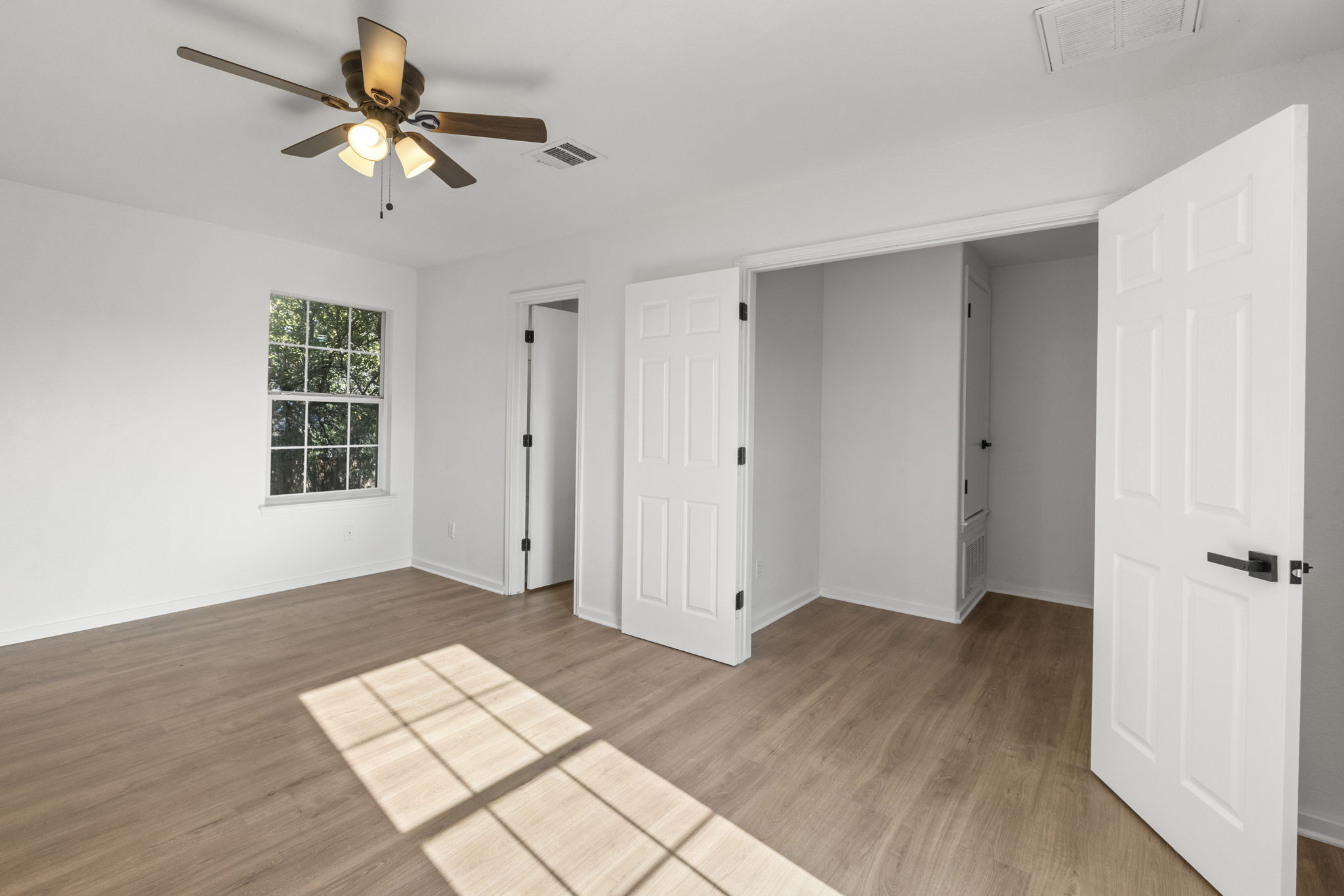 2110 Nogales Trail Austin, TX 78744 - Photo 22 of 37 wooden floor in an empty room with a window
