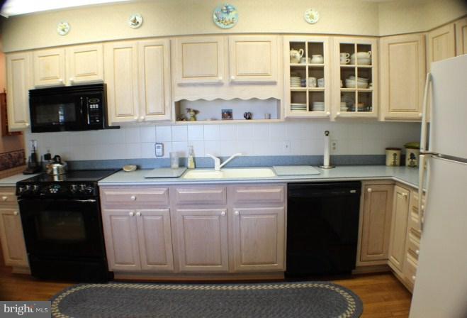 204 Thompson Road Chester, MD 21619 - Photo 12 of 30 a kitchen with stainless steel appliances granite countertop a sink stove and microwave