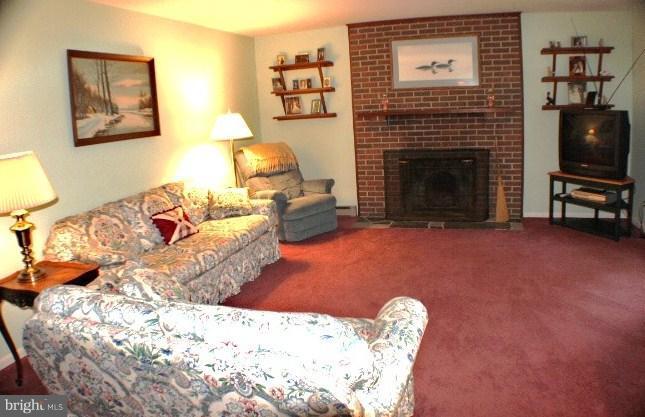 204 Thompson Road Chester, MD 21619 - Photo 13 of 30 a living room with furniture a flat screen tv and a fireplace