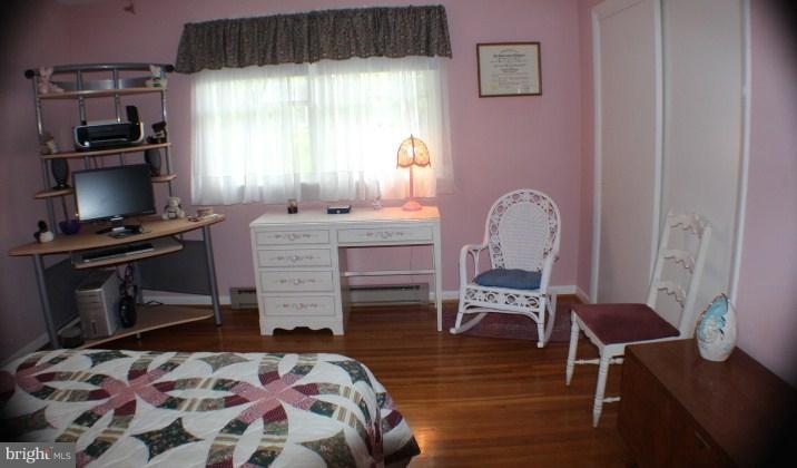 204 Thompson Road Chester, MD 21619 - Photo 14 of 30 a bedroom with a bed and a chair