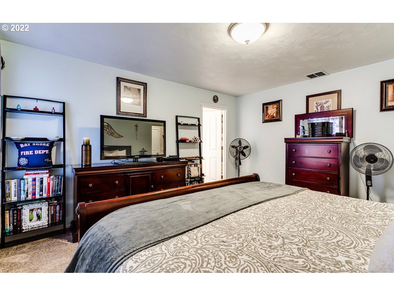 756 South 48th Street Springfield, OR 97478 - Photo 22 of 31 a bedroom with a bed a dresser and book shelf