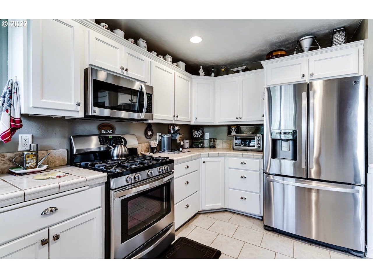 756 South 48th Street Springfield, OR 97478 - Photo 10 of 31 a kitchen with stainless steel appliances granite countertop a refrigerator a stove a sink and white cabinets