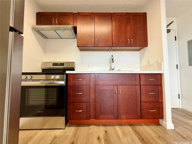 a kitchen with a stove and a cabinet