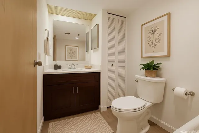 a bathroom with a sink vanity mirror and toilet