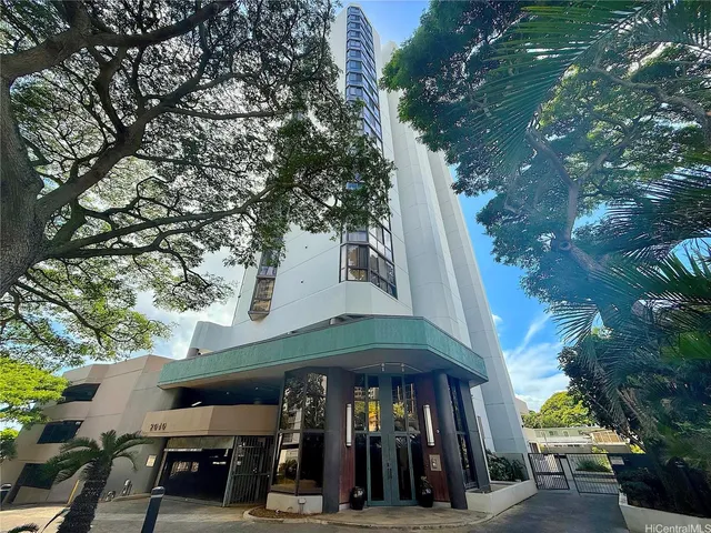 a view of a chairs and umbrellas in a yard