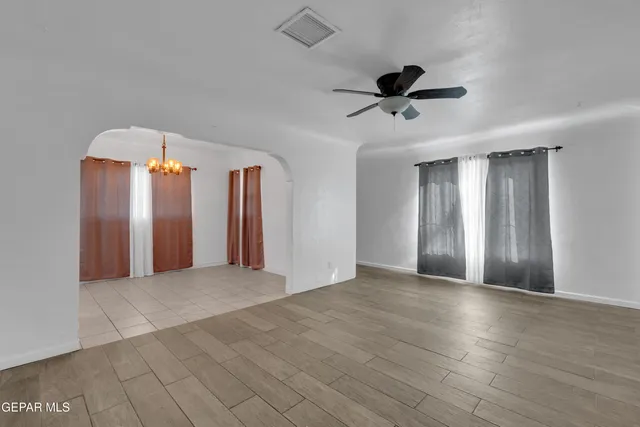 a view of an empty room with a ceiling fan