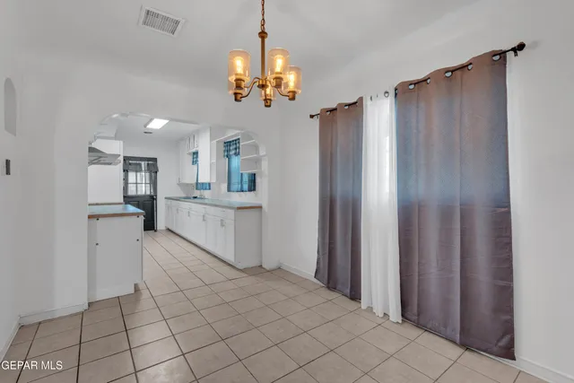 a view of a kitchen with a refrigerator and a sink