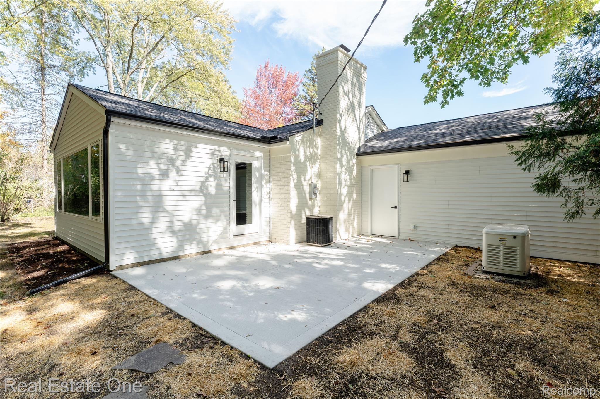 786 South Cranbrook Road Bloomfield Hills, MI 48301 - Photo 31 of 38 Back of property featuring a patio area, a chimney, and a shingled roof