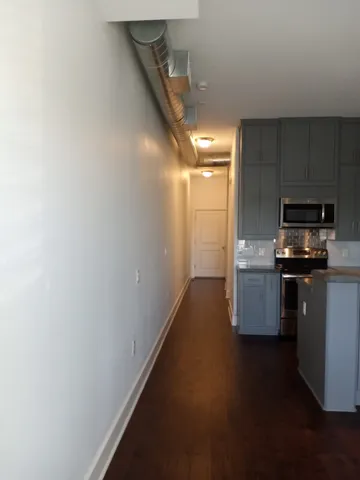 a kitchen with a refrigerator and a stove