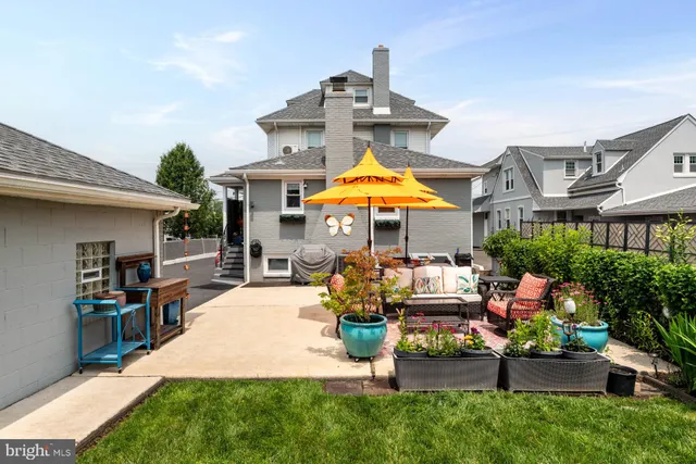 a front view of a house with yard and patio
