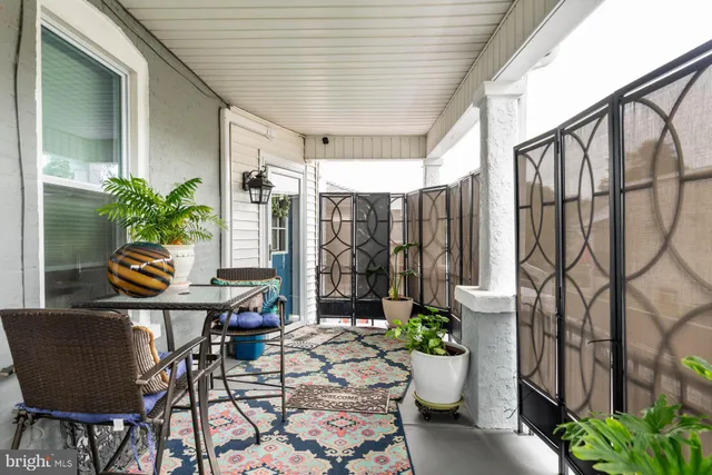 a view of a balcony with chair and potted plants
