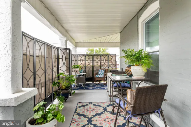 a view of a dining room with furniture and garden view