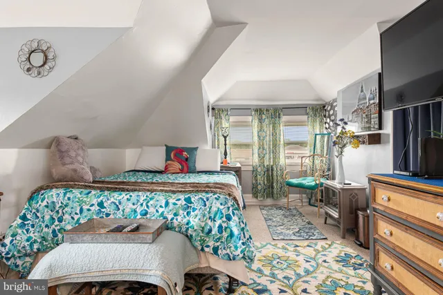 a bedroom with a bed and a dresser in it