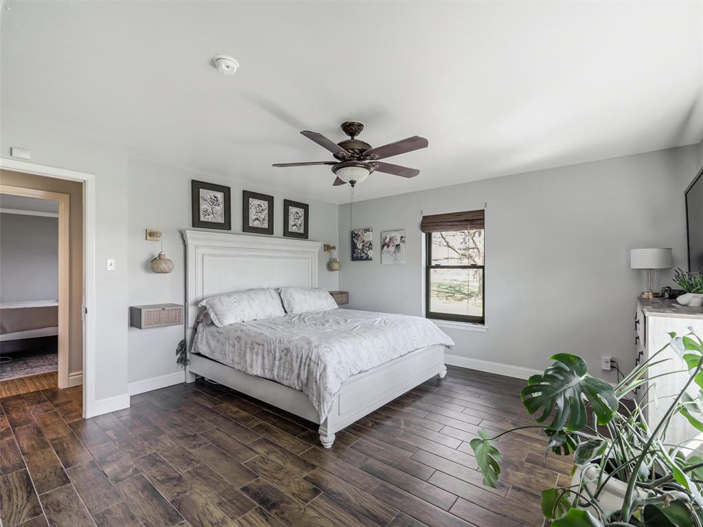 62 Sanders Road Whitesboro, TX 76273 - Photo 12 of 19 A generously sized primary suite provides plenty of room to unwind, with soft natural light and a clean, neutral palette.