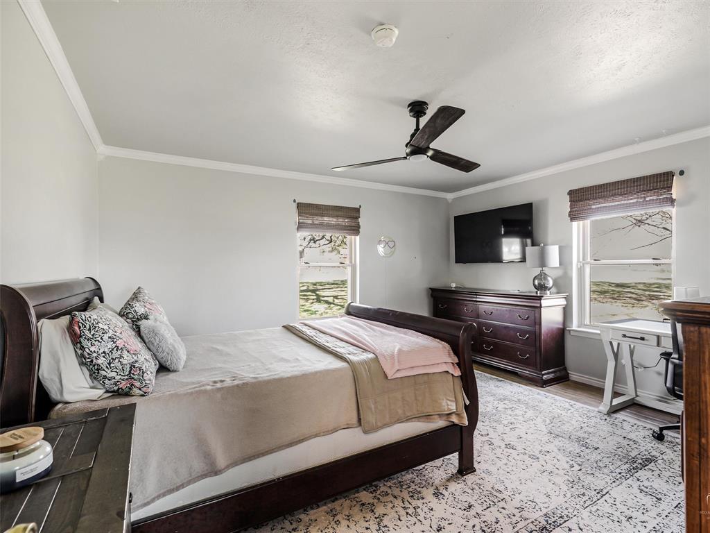 62 Sanders Road Whitesboro, TX 76273 - Photo 14 of 19 This comfortable secondary bedroom features great natural light and flexible space for guests, family, or a home office.