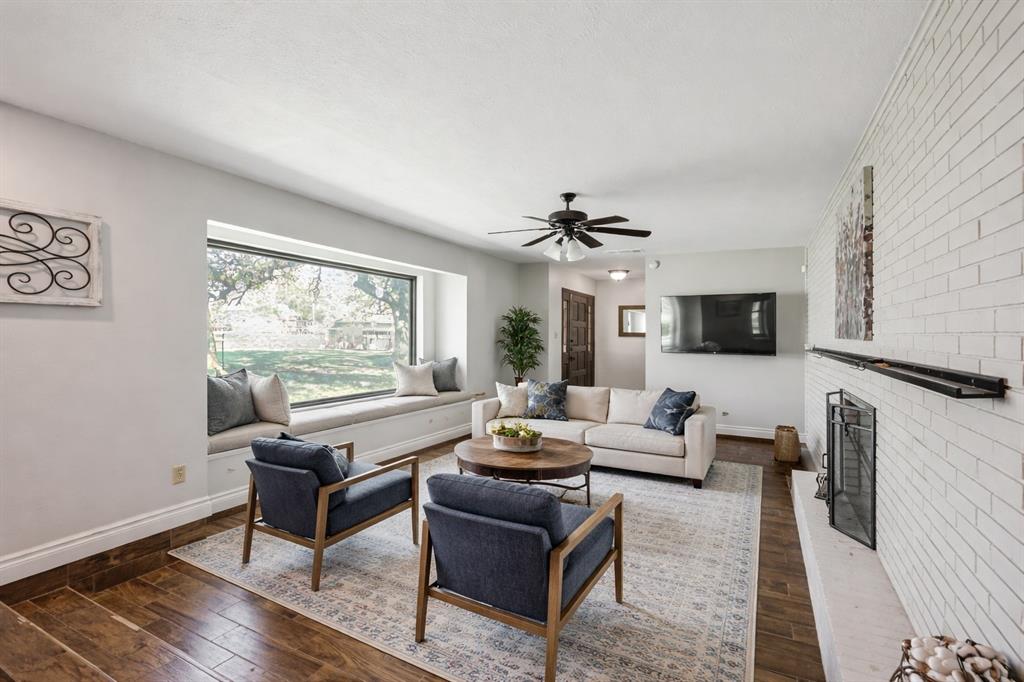 62 Sanders Road Whitesboro, TX 76273 - Photo 2 of 19 Sunlight pours through oversized windows, filling the front living space with warmth and natural light.