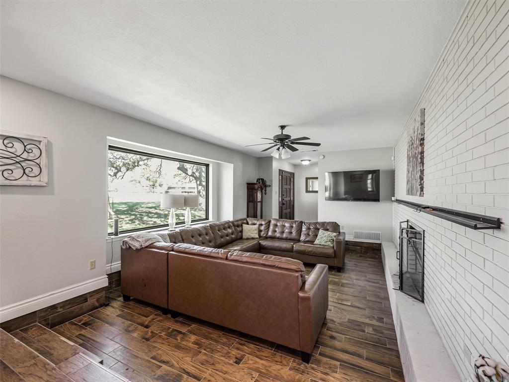62 Sanders Road Whitesboro, TX 76273 - Photo 3 of 19 Another layout option shown here in this bright living room with fireplace