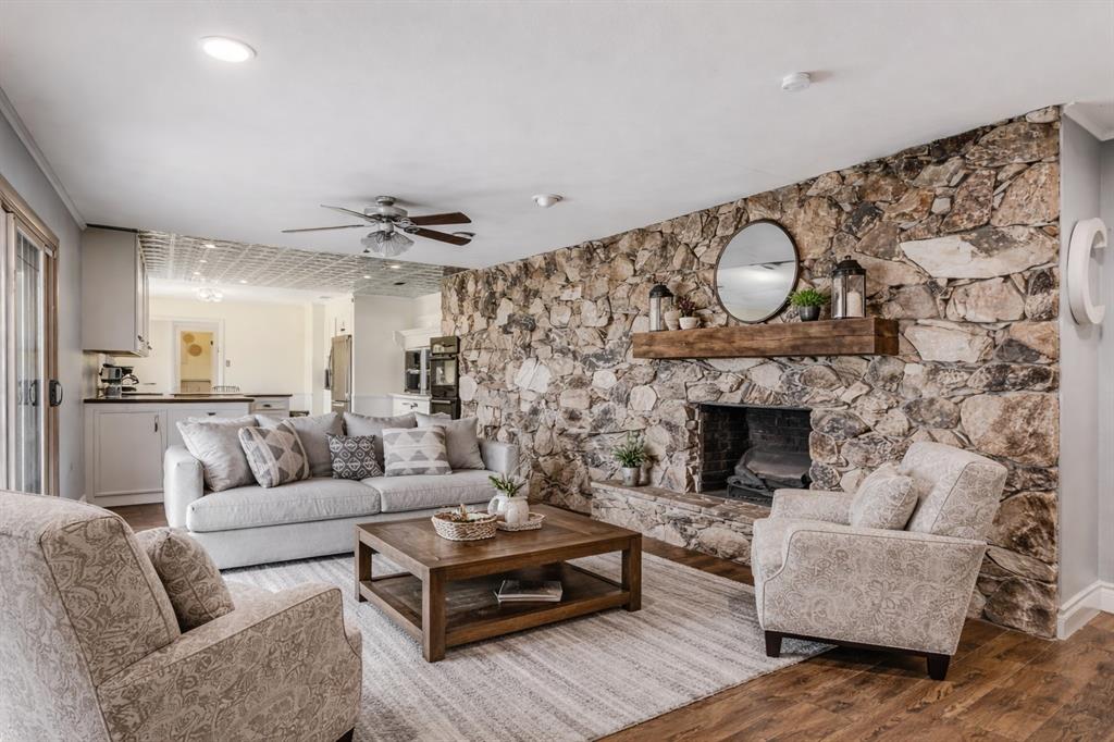 62 Sanders Road Whitesboro, TX 76273 - Photo 10 of 19 Here, we've added a mantel to show the potential. Beautifully arranged around the stunning stone fireplace, this living space blends comfort and character in a layout perfect for relaxing or entertaining.