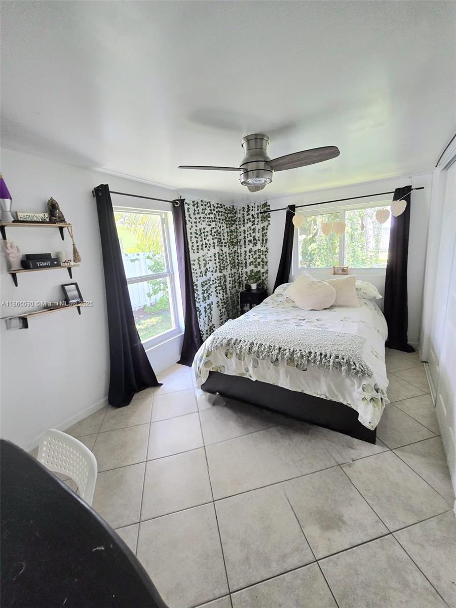6120 Edwards Road Margate, FL 33063 - Photo 27 of 47 a bedroom with a large bed and a window