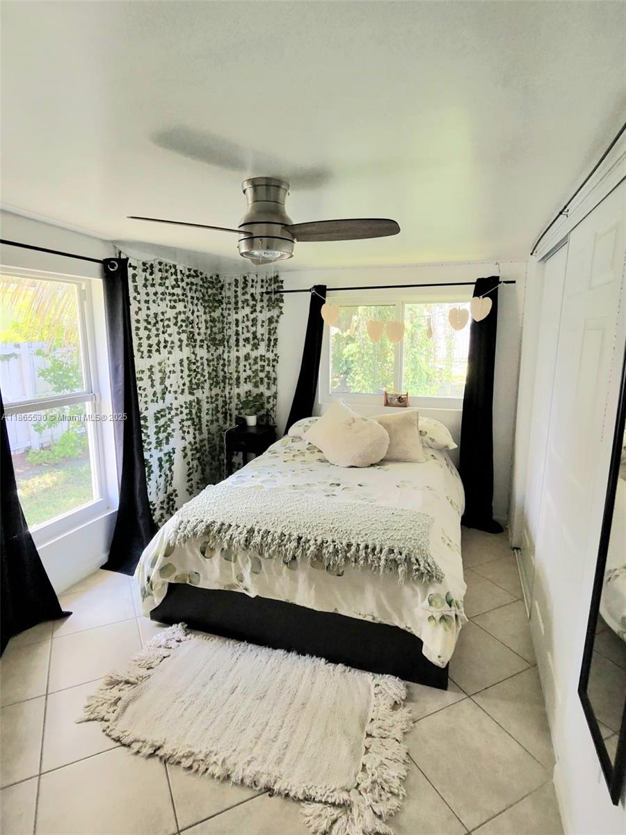 6120 Edwards Road Margate, FL 33063 - Photo 29 of 47 a large bed sitting in a bedroom next to a window