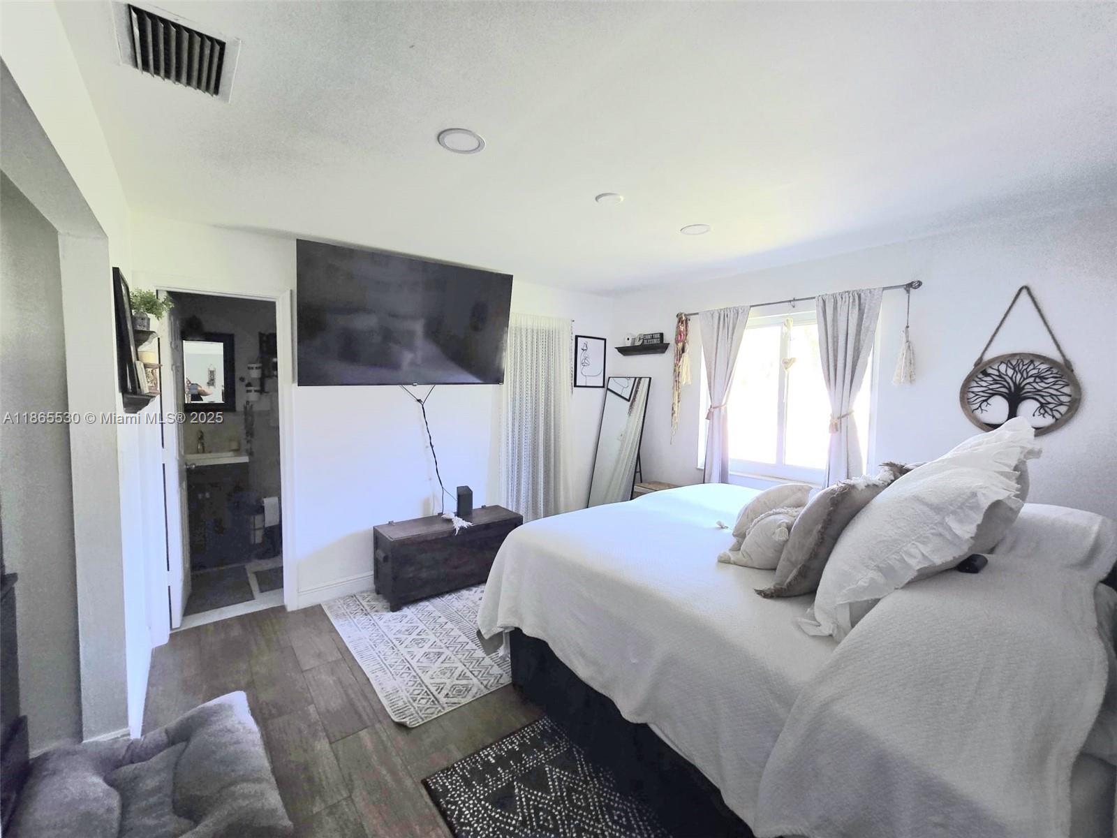 6120 Edwards Road Margate, FL 33063 - Photo 4 of 47 a bedroom with a bed and a television