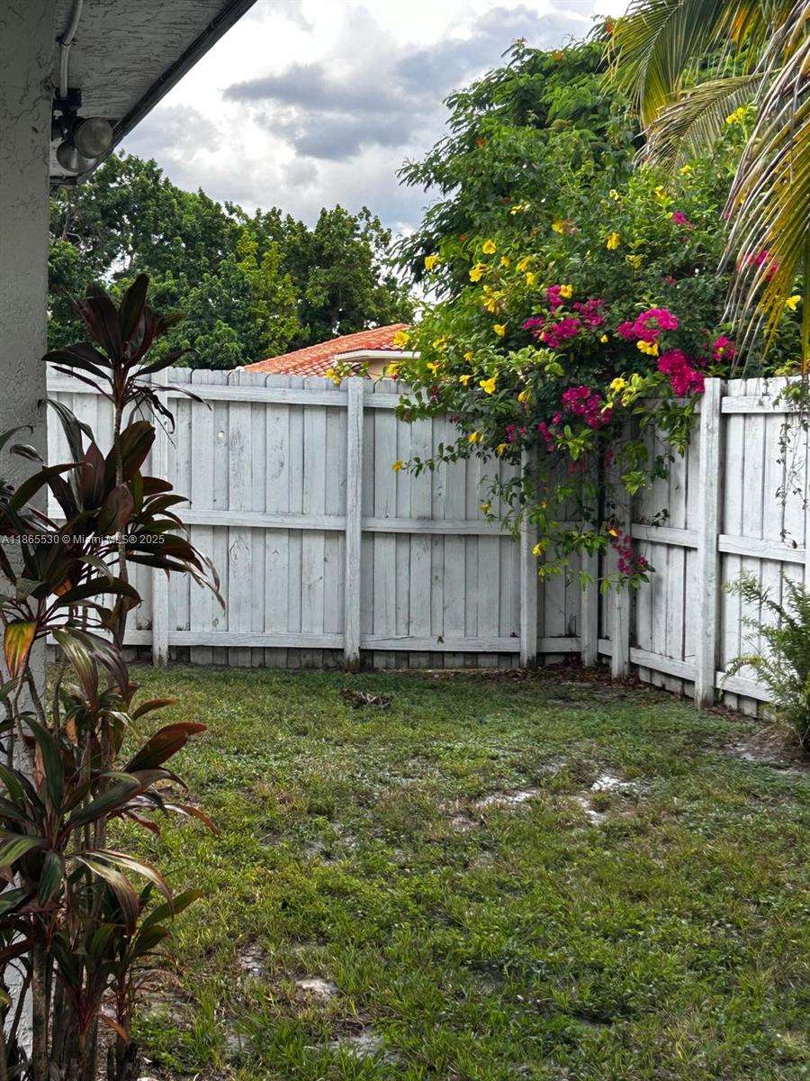6120 Edwards Road Margate, FL 33063 - Photo 45 of 47 a garden with wooden fence