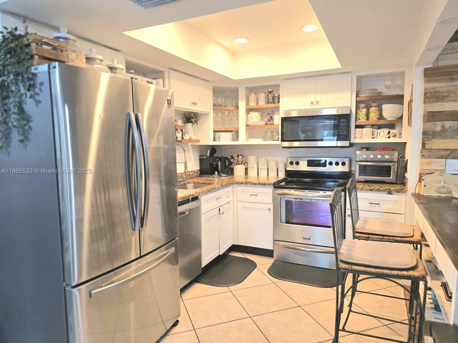 6120 Edwards Road Margate, FL 33063 - Photo 8 of 47 a kitchen with stainless steel appliances a refrigerator stove and sink