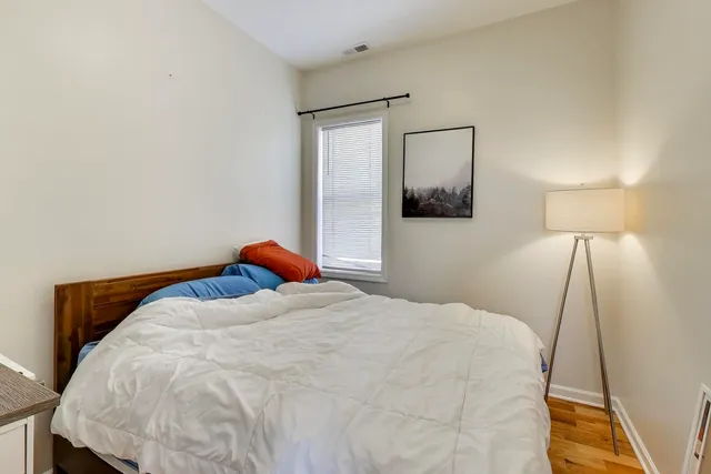 a bedroom with a bed and a lamp