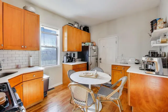 a kitchen with a table and chairs in it