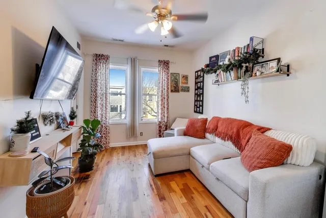 a living room with furniture and wooden floor