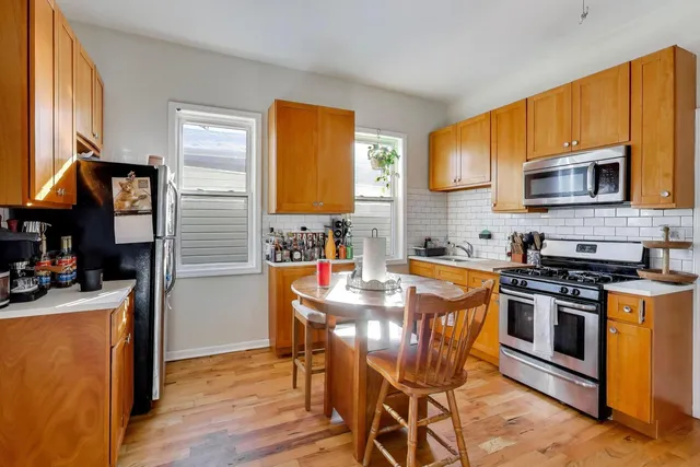 a kitchen with stainless steel appliances a stove a sink dishwasher and a refrigerator