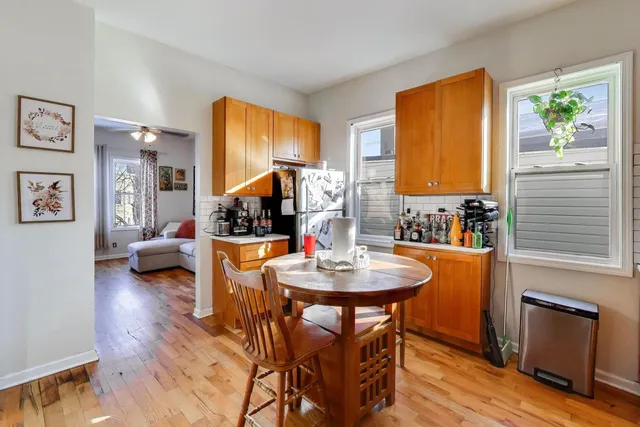 a dining room with furniture and wooden floor