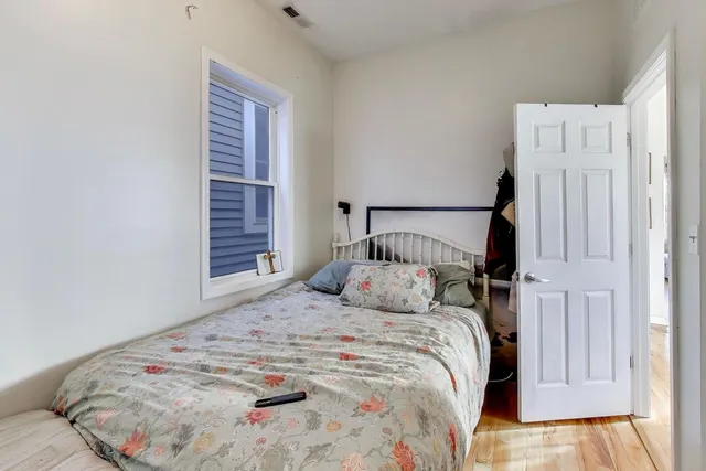 a bedroom with a bed and a window