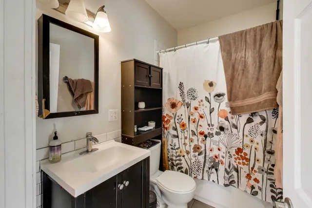 a bathroom with a sink toilet and shower