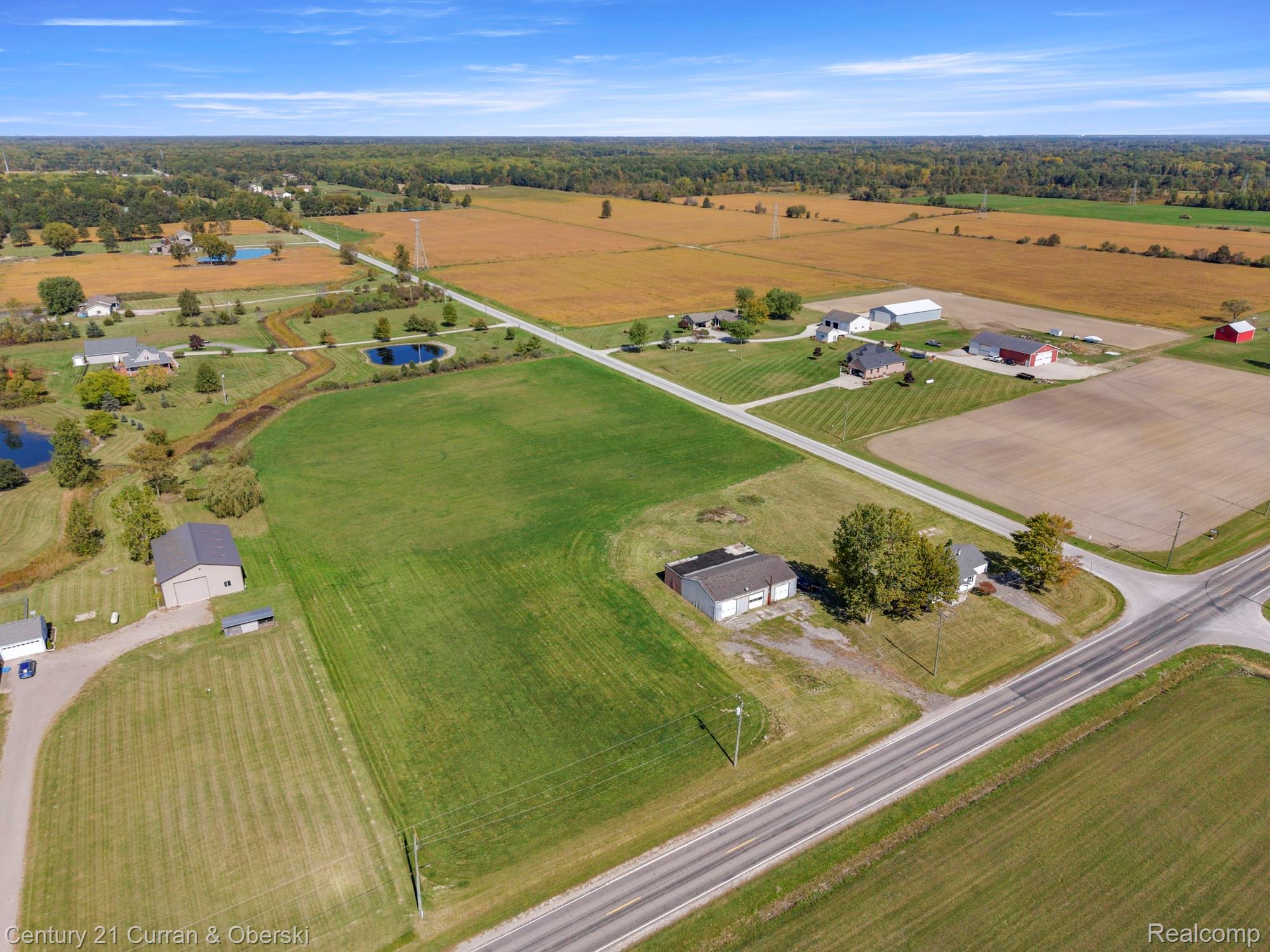 7504 Meisner Road Casco, MI 48064 - Photo 24 of 27 Expansive land featuring agricultural fields, established roadways, and multiple outbuildings