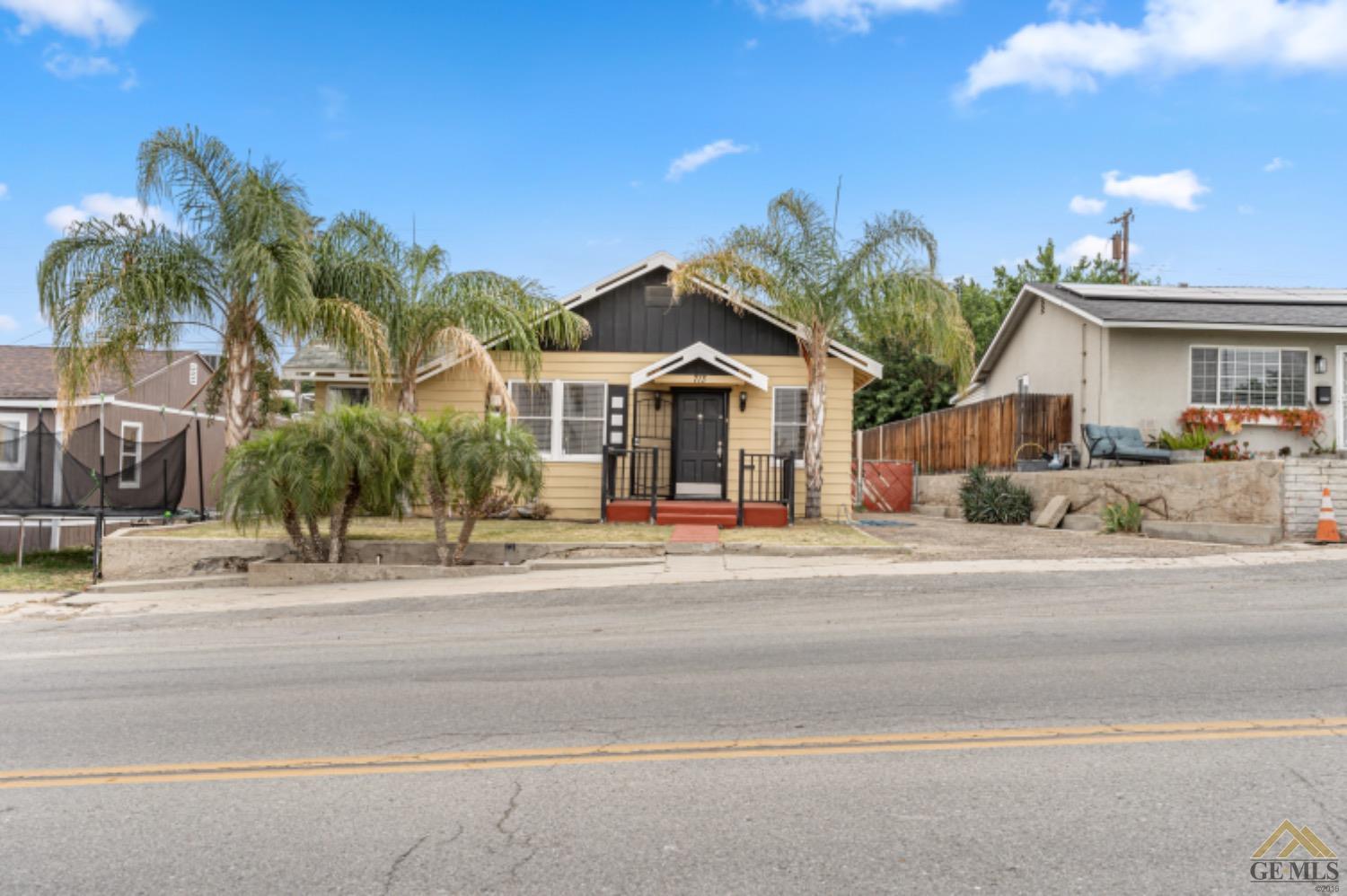 a front view of a house with a garden and a garage