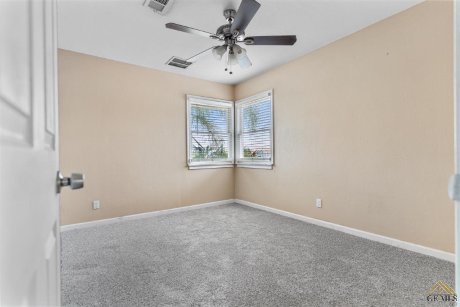 Undisclosed Address Taft, CA 93268 - Photo 5 of 17 an empty room with windows and fan