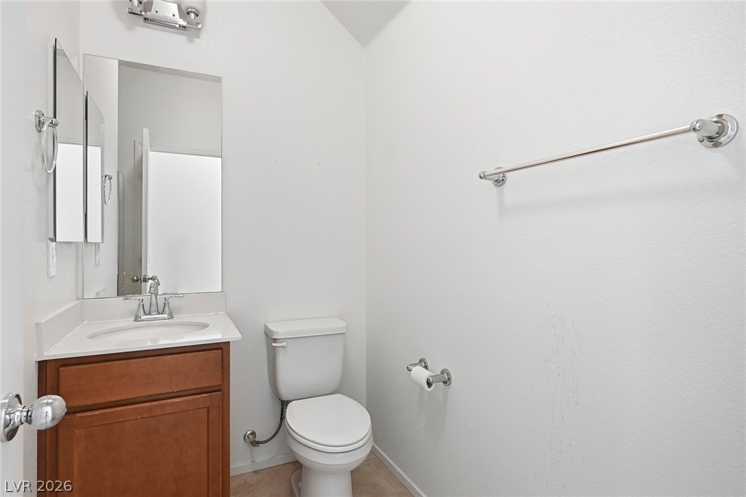 250 Dedication Avenue Henderson, NV 89011 - Photo 6 of 67 Half bath with vanity and toilet