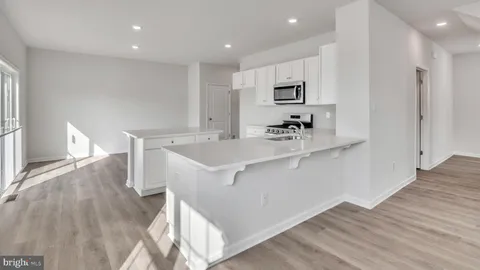 a kitchen with a sink cabinets and wooden floor