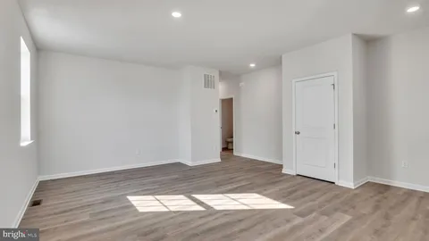 a view of an empty room and wooden floor