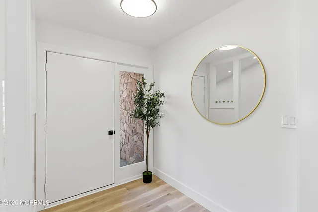 a view of a room with wooden floor and entryway