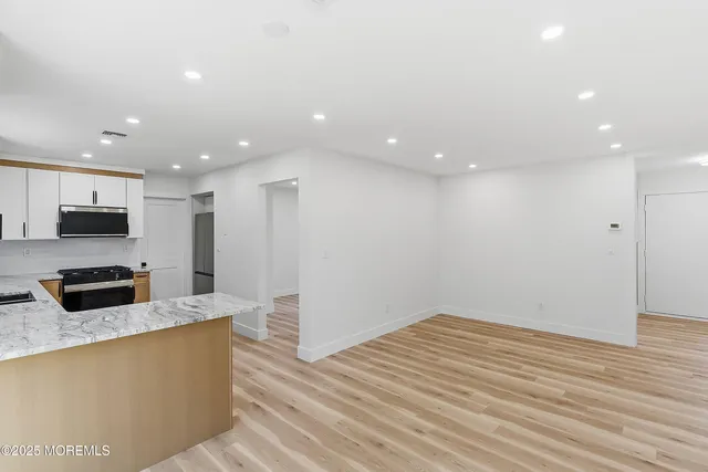 a kitchen with stainless steel appliances a refrigerator sink and microwave