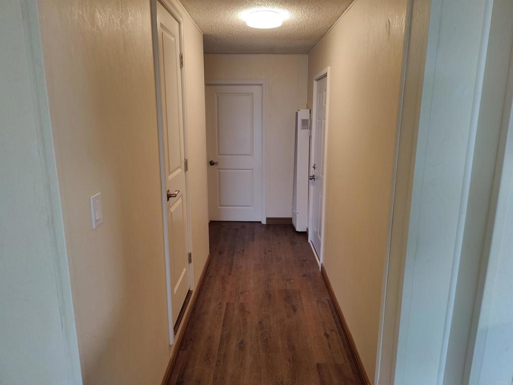 5382 Bonita Drive San Diego, CA 92114 - Photo 12 of 15 a view of a hallway with wooden floor