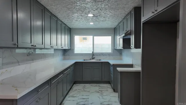 a kitchen with stainless steel appliances granite countertop a sink stove and cabinets