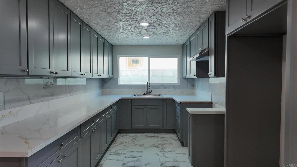 5382 Bonita Drive San Diego, CA 92114 - Photo 13 of 15 a kitchen with stainless steel appliances granite countertop a sink stove and cabinets