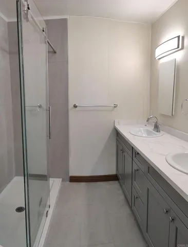 a bathroom with a double vanity sink and mirror