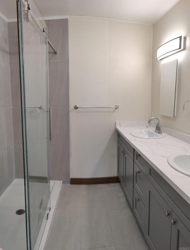 5382 Bonita Drive San Diego, CA 92114 - Photo 2 of 15 a bathroom with a double vanity sink and mirror