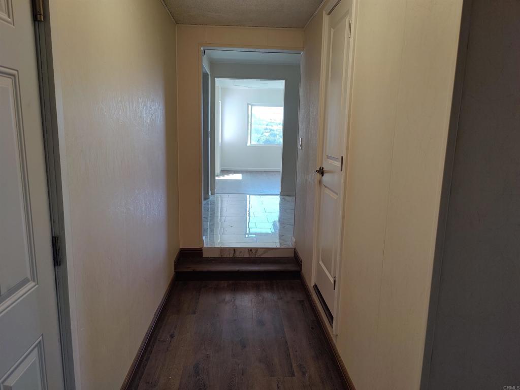 5382 Bonita Drive San Diego, CA 92114 - Photo 10 of 15 a view of a hallway with wooden floor and a bathroom